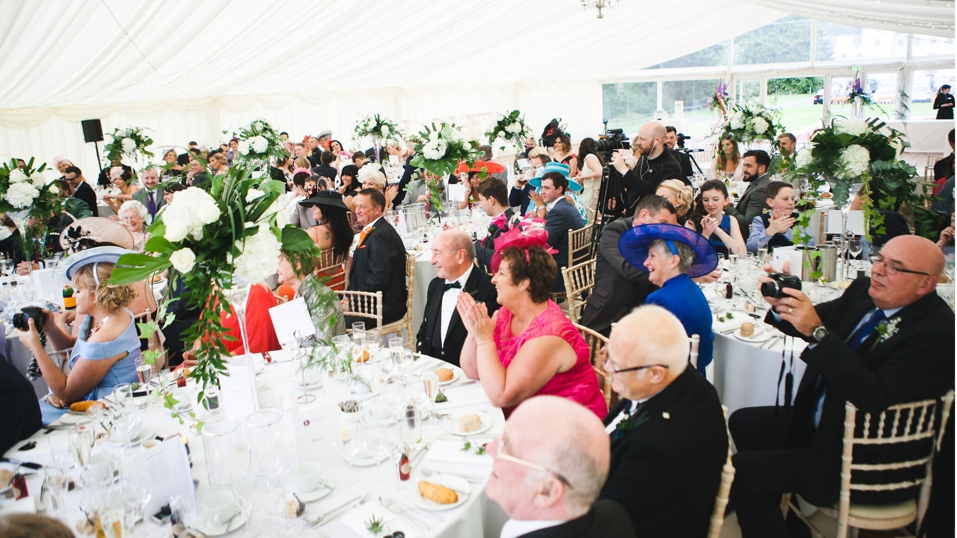 Wedding guests at a marquee reception at Barony Castle